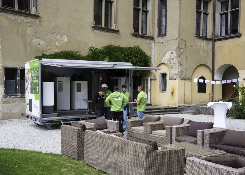 Mitarbeiteraustausch vor dem Ausstellungsfahrzeug von Novelan Wärmepumpen